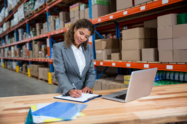 istock Business woman writing on her clipboard 658528810