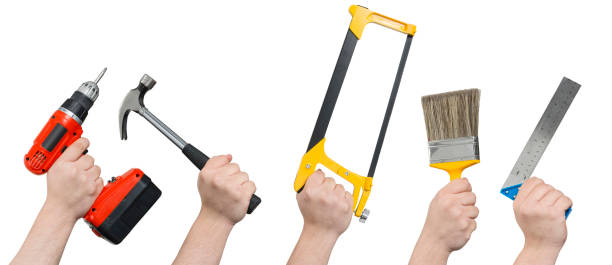 istock Screwdriver, Hammer, Hacksaw, Paintbrush, and Ruler in Hands Clipping Path 658531244