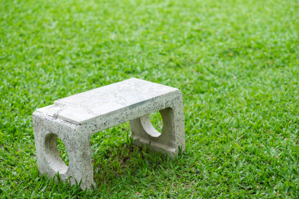 istock Old marble chair on green grass. 658531438