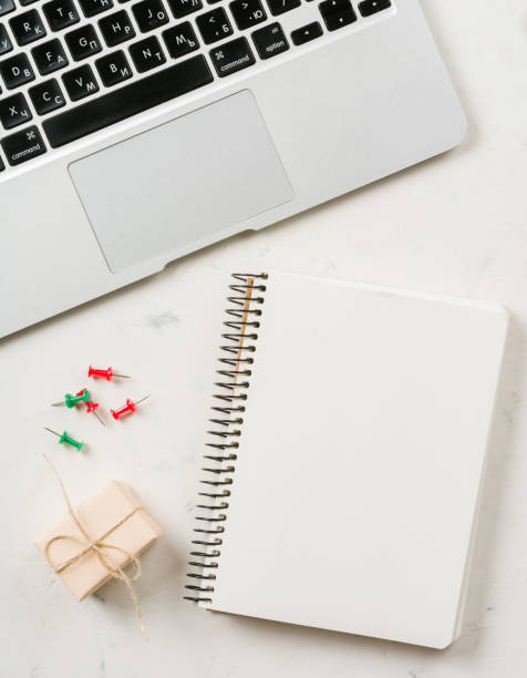 istock Business background with laptop and notepad on white stone background. 658538720