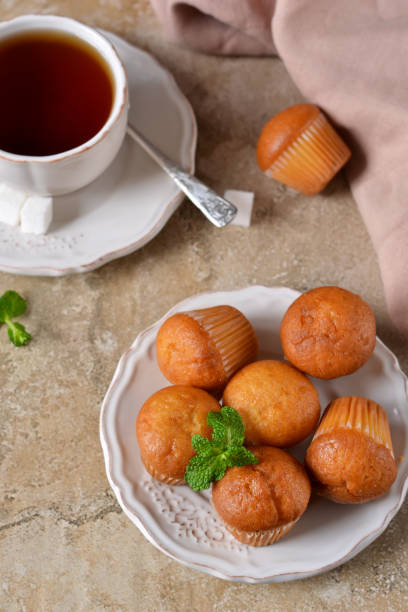 istock Vanilla cupcakes with banana for breakfast on a concrete background 658539430