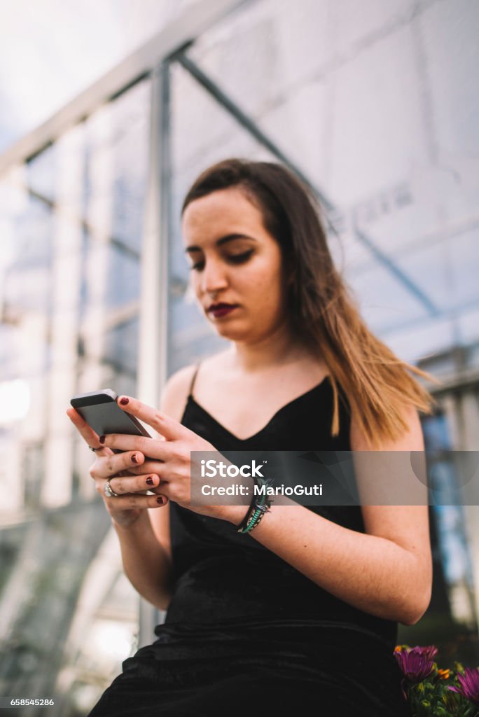 Young woman using smartphone A young woman holding an smartphone 20-29 Years Stock Photo