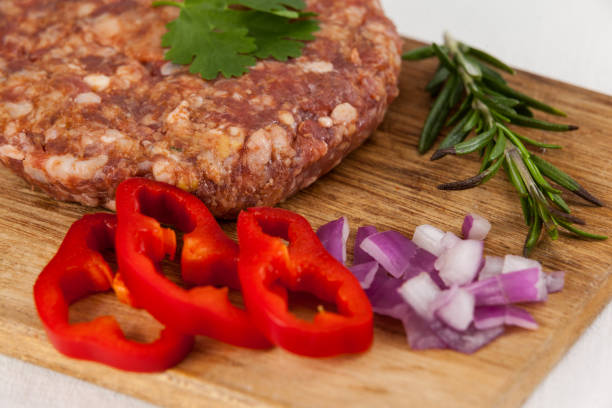 istock Beef patty and ingredients on wooden tray 658545816