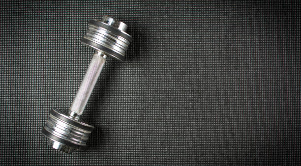 istock Metal dumbbell on  yoga mat 658549612
