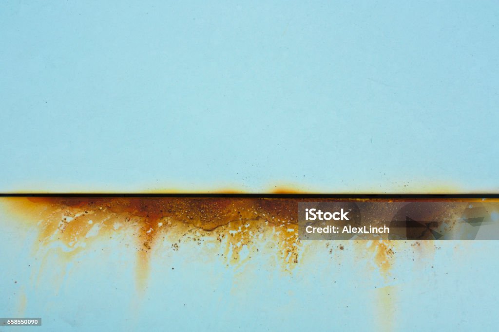 Baby blue metal with rusty cut Baby blue metal with rusty orange cut, a detail of an old car Rusty Stock Photo