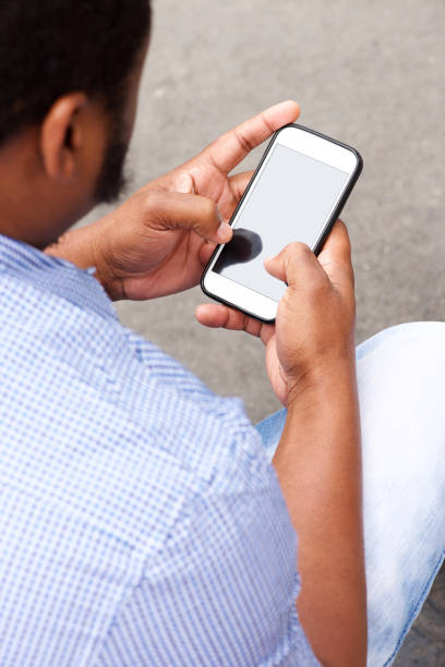 istock over shoulder portrait of man looking at cellphone screen 658550948