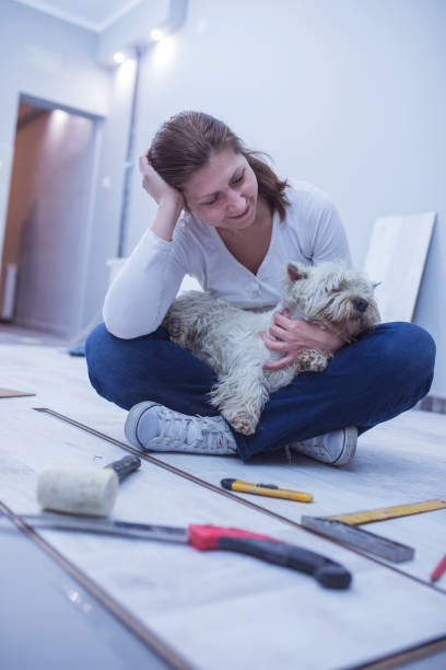 istock Woman installing a wooden floor 658556542