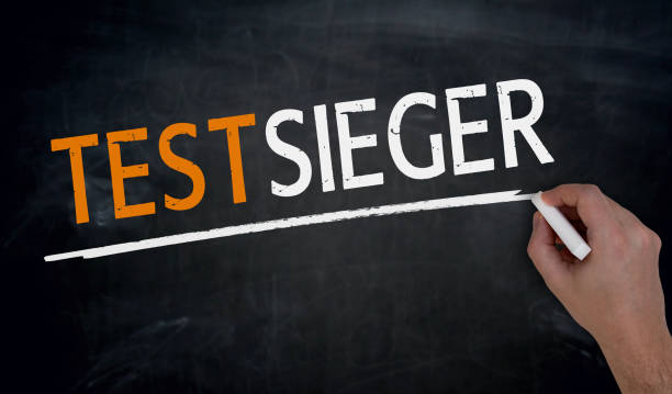 istock testwinner (in german Test winner) is written by hand on blackboard 658557352