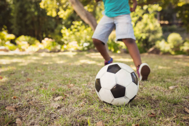 istock happy child playing football 658557390