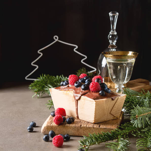 Christmas cake with chocolate frosting, blueberries and raspberr