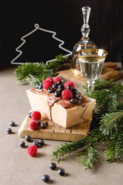 Christmas cake with chocolate frosting, blueberries and raspberr