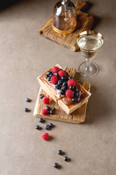 istock Christmas cake with chocolate frosting, blueberries and raspberr 658557910