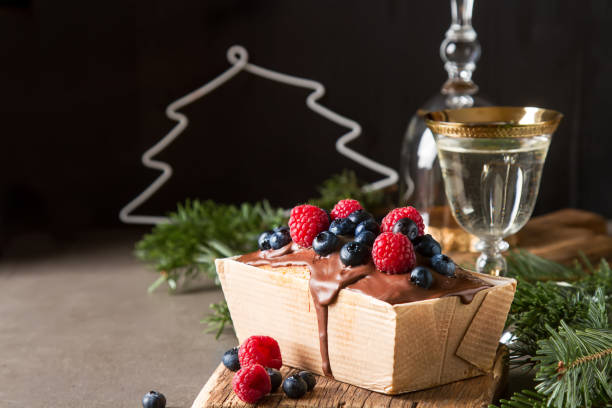 Christmas cake with chocolate frosting, blueberries and raspberr