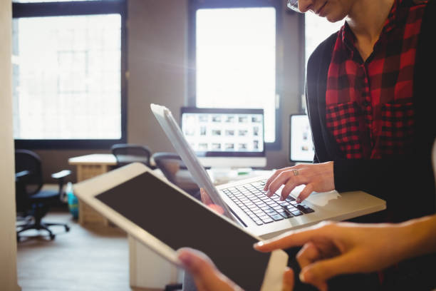 istock Two female graphic designer using digital tablet and laptop 658561012