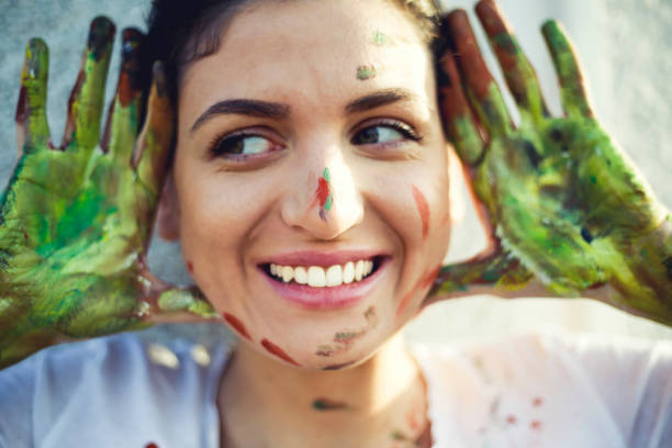 istock Smiling young woman have a fun with colors 658561262