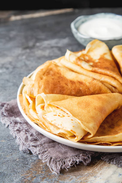 istock Stack of pancakes on a plate with sour cream. Traditional for th 658561450