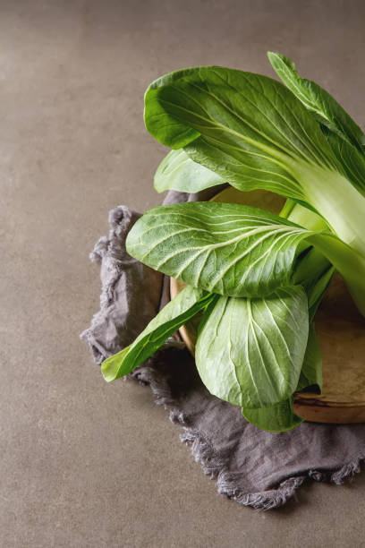 istock Overhead shot of Chinese cabbage, Bok Choy, on rustic background 658561642