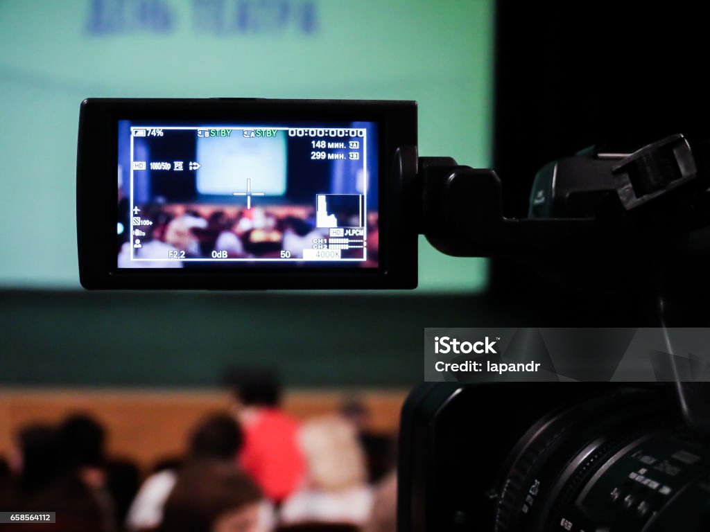 Shooting concert video. Control monitor. Blurred background, bokeh. Videography Shooting concert video. Control monitor. Blurred background, bokeh. Videography. Home Video Camera Stock Photo