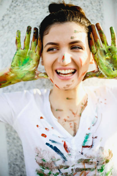 istock Smiling young woman have a fun with colors 658564552