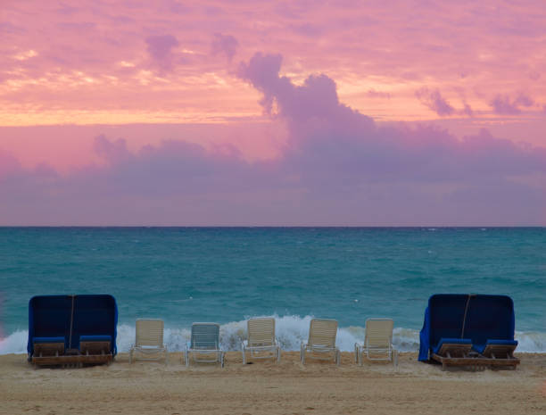 istock Chairs at the beach overlooking sunset 658564622
