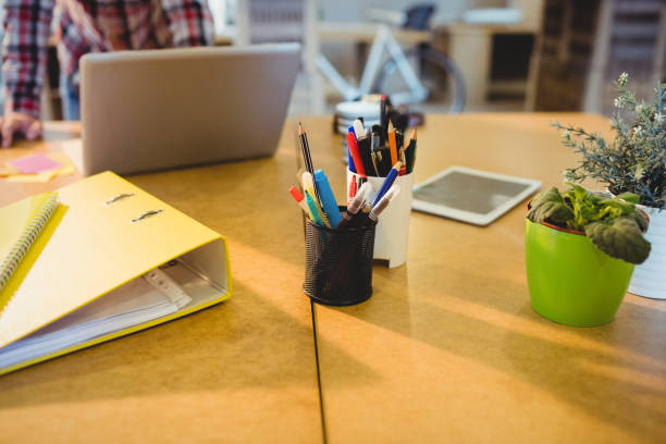 istock Pen holder with pens and file on table 658565184