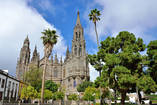 View on Medieval beautiful parish church of San Juan Bautista - impressive Gothic Cathedral in Arucas, Gran Canaria, Spain.