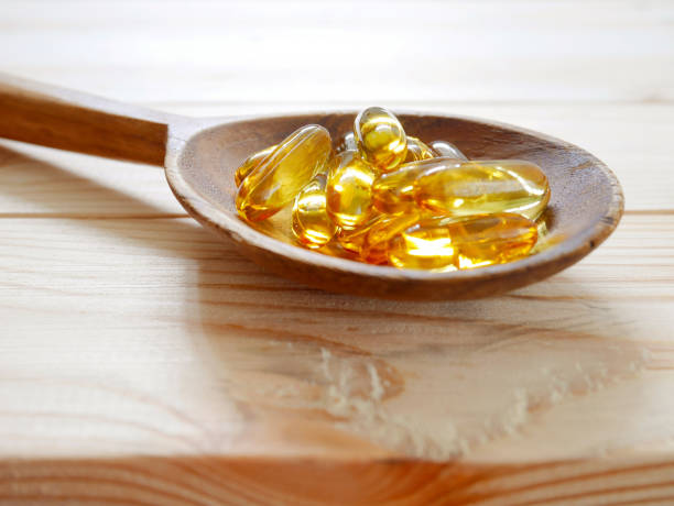 istock Fish oil capsules on wooden spoon 658568832
