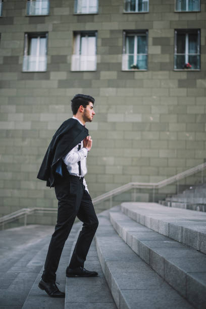 istock Young man wearing a suit going up 658568920