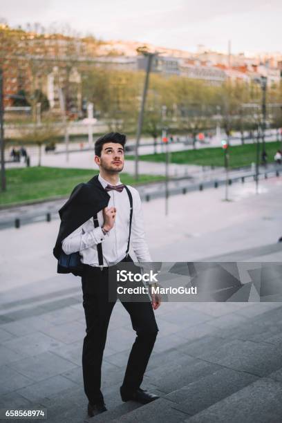 Young Man Wearing A Suit Going Up Stock Photo - Download Image Now - 20-29 Years, Adolescence, Adult