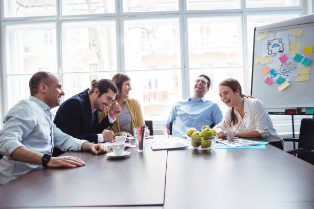 istock Cheerful colleagues discussing in meeting room 658571846