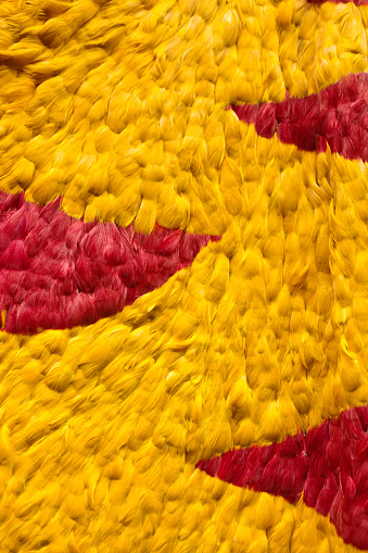 A reproduction of the historical royal cape of the Hawaiian royalties. The 'Ahu 'ula. Completely made of yellow and red feather. An iconic symbol of the royal family the high ranking chiefs, the ruling class of the Hawaiian culture.