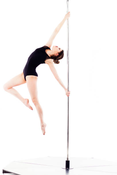 Woman doing pole dance, isolated on white Woman doing pole dance, isolated on white background black pole dancers stock pictures, royalty-free photos & images