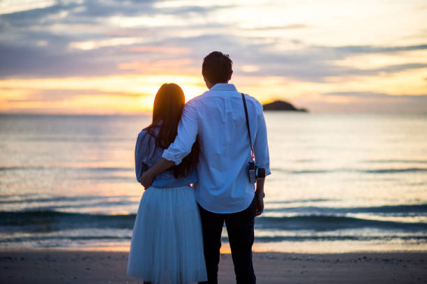 istock Happy Romantic young Couple Enjoying Beautiful Sunset 658580824