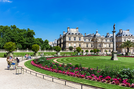 Paris, France - July 07, 2016: People enjoy sunny day in the Luxembourg Gardens in Paris. Luxembourg Palace is the official residence of the French Senate.