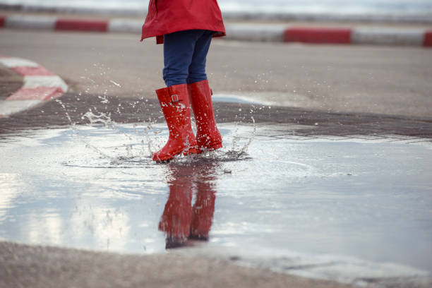 istock Jumping on puddles in rainy day. 658587426