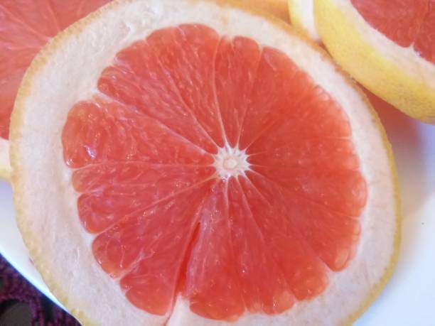istock The cloves of red grapefruit on the white plate 658587810