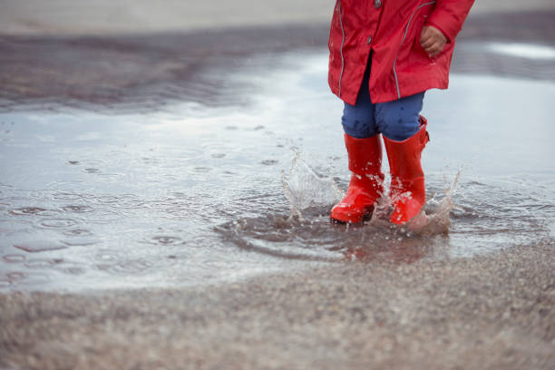 istock Jumping on puddles in rainy day. 658588514