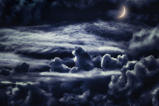 dreamy cloudscape at night with moonlight