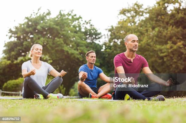 Group Of People Meditating Stock Photo - Download Image Now - Yoga, Meditating, Zen-like