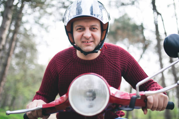 istock Young hipster man in helmet sitting on a vintage scooter . 658596792