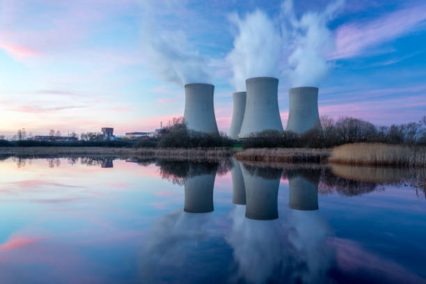Nuclear power plant with dusk landscape. Nuclear power plant after sunset. Dusk landscape with big chimneys. radioactive contamination stock pictures, royalty-free photos & images