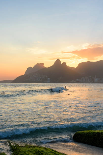 Landscape of Arpoador bech in Ipanema with hills and surfers