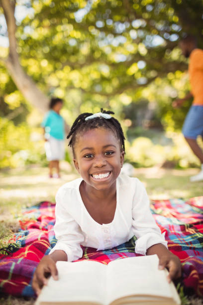 istock Happy girl reading a book 658599290