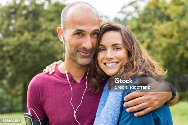 Couple Relaxing After Jogging Stock Photo - Download Image Now - Couple - Relationship, Exercising, Mature Couple