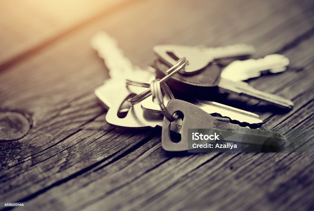 The bunch of keys on a wooden table. The bunch of keys lies on a wooden table. Key Stock Photo
