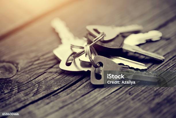 The Bunch Of Keys On A Wooden Table Stock Photo - Download Image Now - Key, Lock, Unlocking