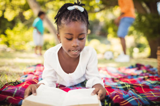 istock Happy girl reading a book 658600468