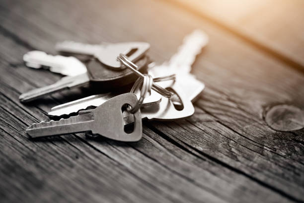 istock The bunch of keys on a wooden table. 658600780