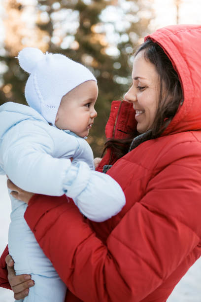 istock Mother with baby in snow 658604566