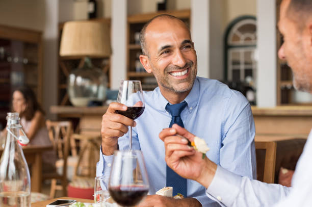 feliz hombre de negocios durante la comida - business meeting business lunch business person fotografías e imágenes de stock